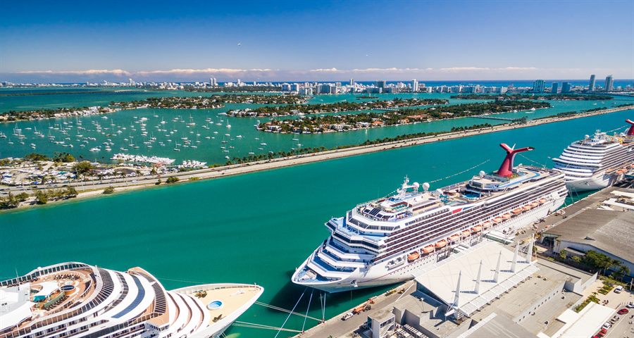 Cruise ships at a port seen from above, with rows of balconies